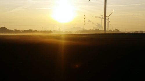 Scenic view of field against sky on sunny day