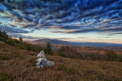 Scenic view of landscape against cloudy sky