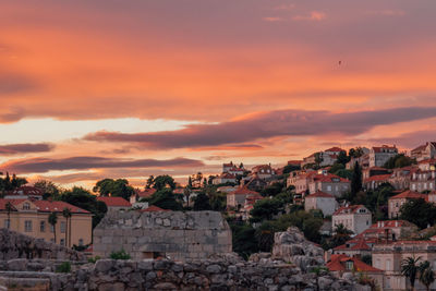 View of town against sky at sunset