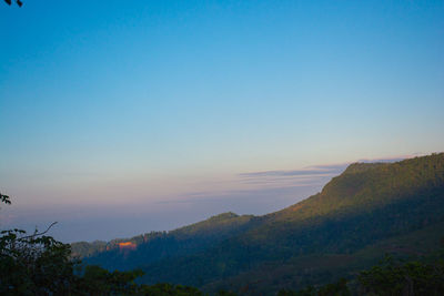 Scenic view of mountains against clear sky at sunset