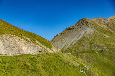 Scenic view of mountains against clear blue sky