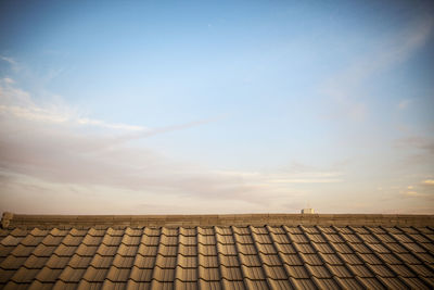 Low angle view of roof and building against sky