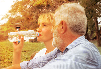 Portrait of man drinking water from bottle