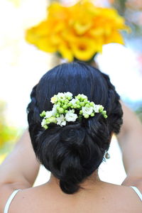 Rear view of woman with flowers