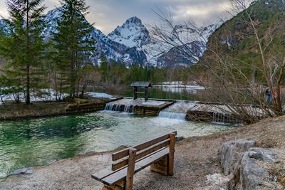 Scenic view of lake by snowcapped mountains during winter