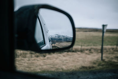 Reflection of car on side-view mirror