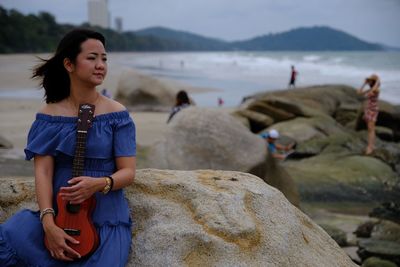 Full length of woman on rocks at beach