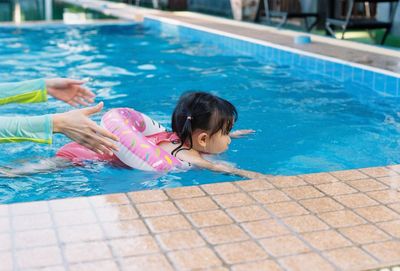High angle view of woman swimming in pool