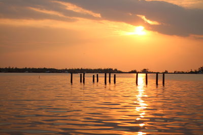 Scenic view of lake against romantic sky at sunset