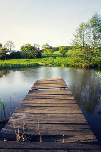 Pier over lake against sky