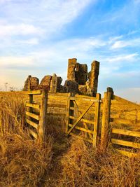 Old ruins on field against sky