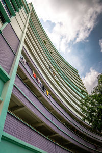 Low angle view of bridge amidst buildings against sky
