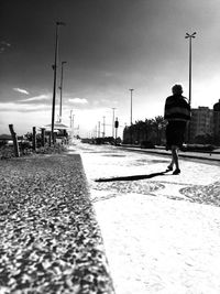 Rear view of people walking on road