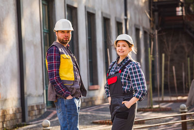 Friends standing at construction site