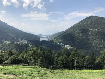 Scenic view of trees and mountains against sky