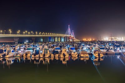 High angle view of boats moored at harbor at night