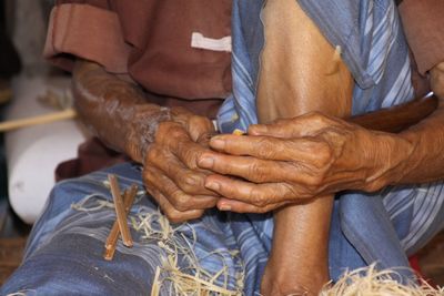 Midsection of man making craft product