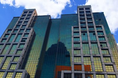 Low angle view of office building against sky