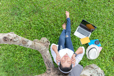 High angle view of woman lying on grass