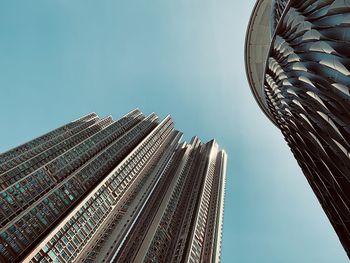 Low angle view of buildings against clear blue sky