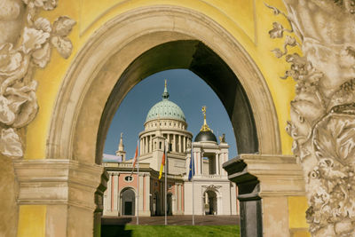 Cathedral seen through arch against sky