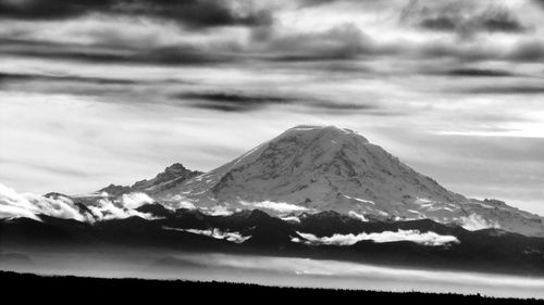 Scenic view of mountains against cloudy sky