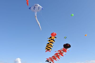 Low angle view of kite against clear blue sky