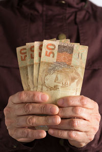 Close-up of man holding paper currencies