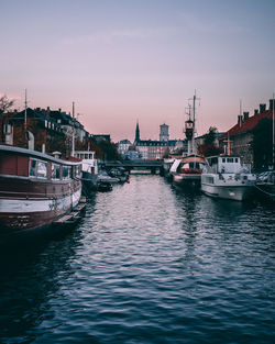 Sailboats moored in harbor