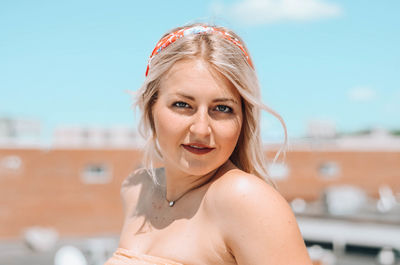 Portrait of beautiful young woman standing outdoors