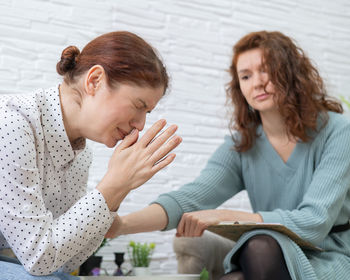 Crying woman sitting by counselor