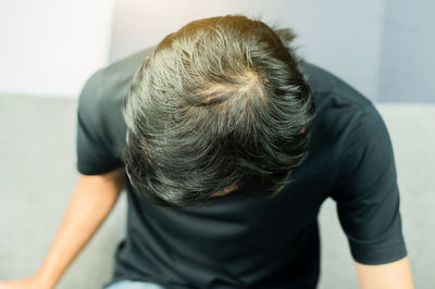 Rear view of man sitting outdoors