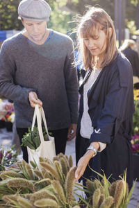 Couple choosing plants in flower market