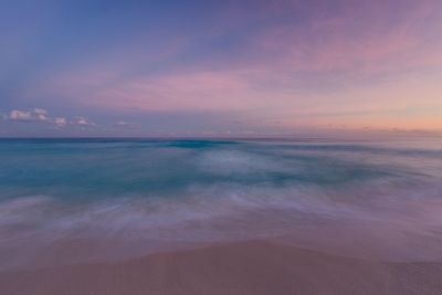 Scenic view of sea against sky at sunset