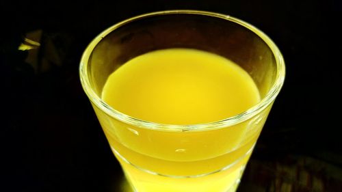 Close-up of yellow juice against black background