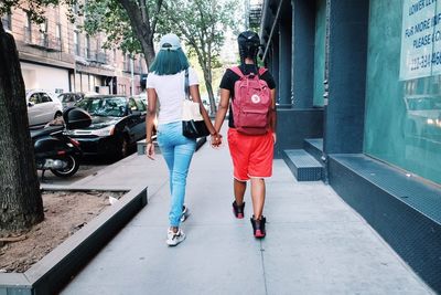 Rear view of people walking on street