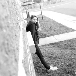 Full length of woman standing on wall