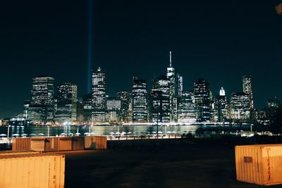 Illuminated cityscape against sky at night