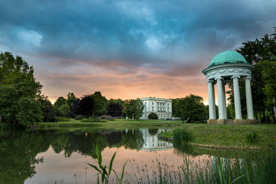 Reflection of building in lake at sunset