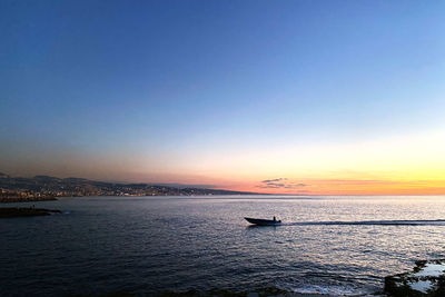 Scenic view of sea against clear sky during sunset