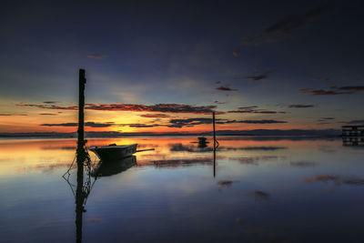 Scenic view of lake against sky at sunset