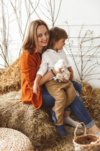 Easter kids playing with rabbits and ducks