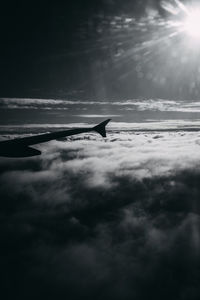 Airplane flying over cloudscape against sky