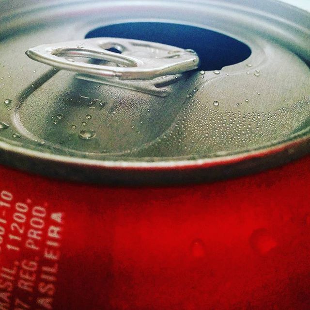 close-up, red, indoors, focus on foreground, still life, metal, text, single object, water, no people, western script, communication, high angle view, metallic, part of, selective focus, number, table, drink, reflection