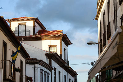 Low angle view of buildings in town against sky