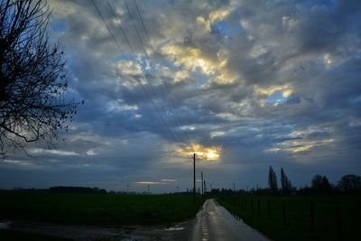 Scenic view of dramatic sky over road during sunset