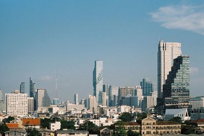 Modern buildings in city against sky