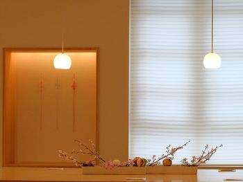 Illuminated lamp on table at home