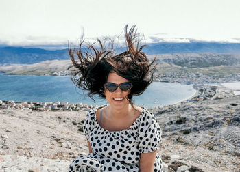 Portrait of smiling young woman at beach