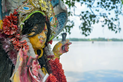 Statue against lake